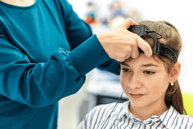 Child with autism undergoing neurofeedback therapy session in Dubai